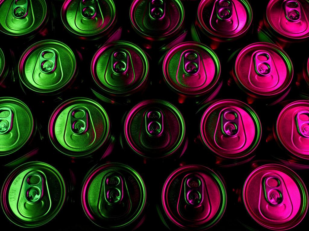 top view of Aluminum cans lit by pink and green lights